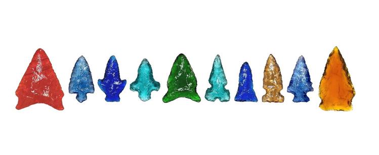 A row of 10 modern flintknapped colored glass points in red (1), light blue (2), cobalt blue (2), aqua (2), green (1), yellow (1) & amber (1).