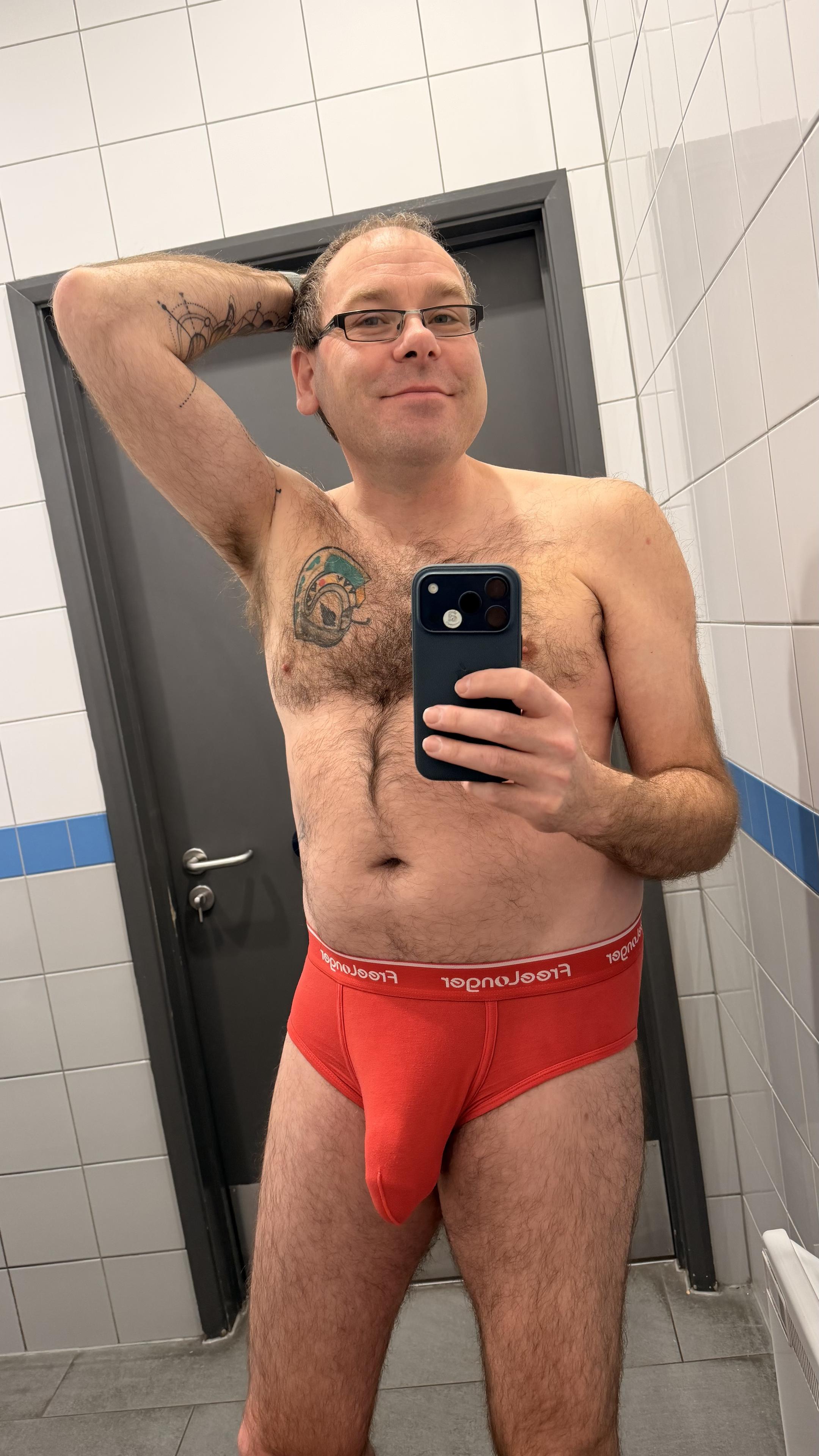 Hairy gay guy wearing red FreeLonger briefs