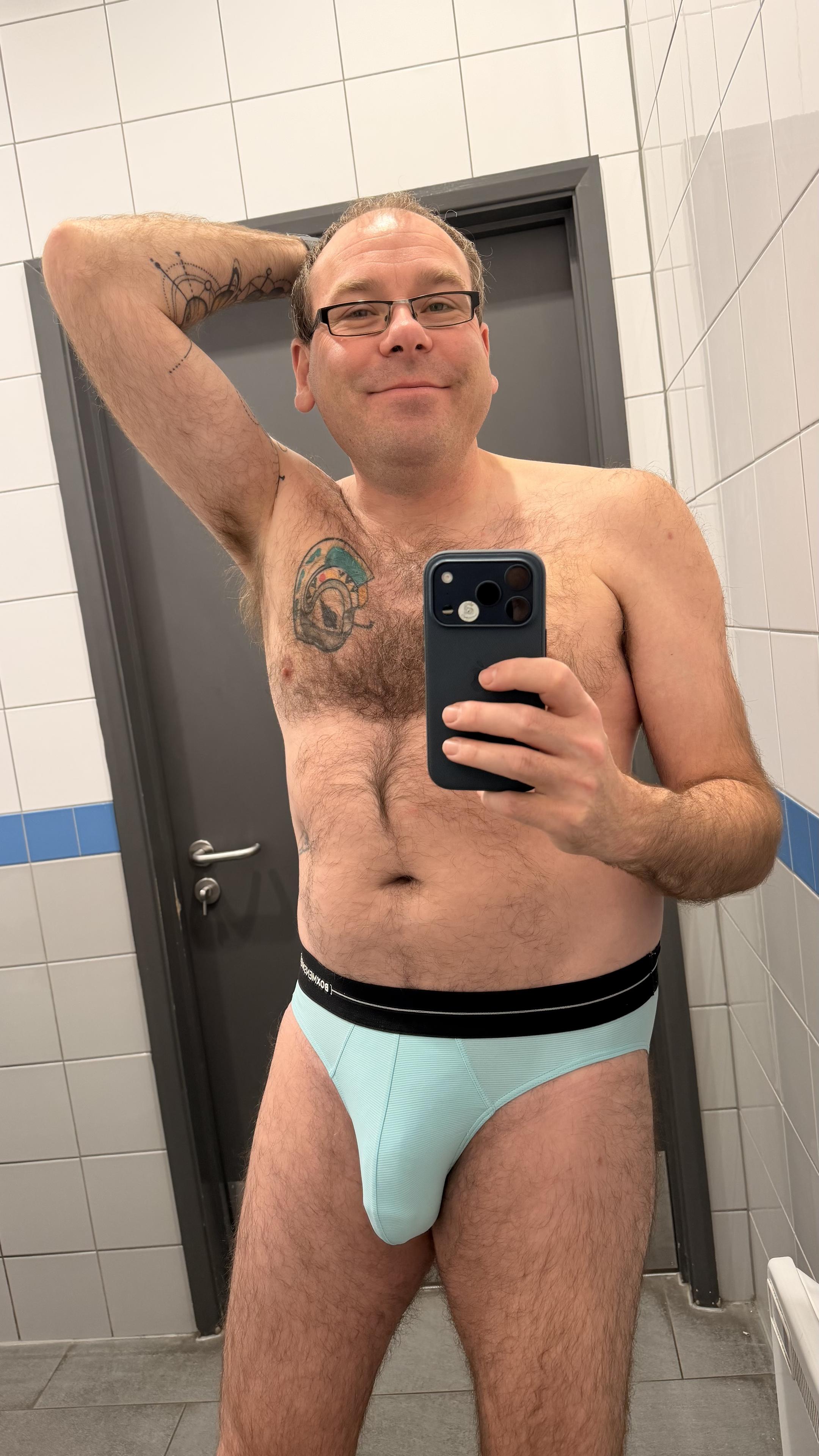 Hairy gay guy wearing aquamarine Box briefs with black waistband