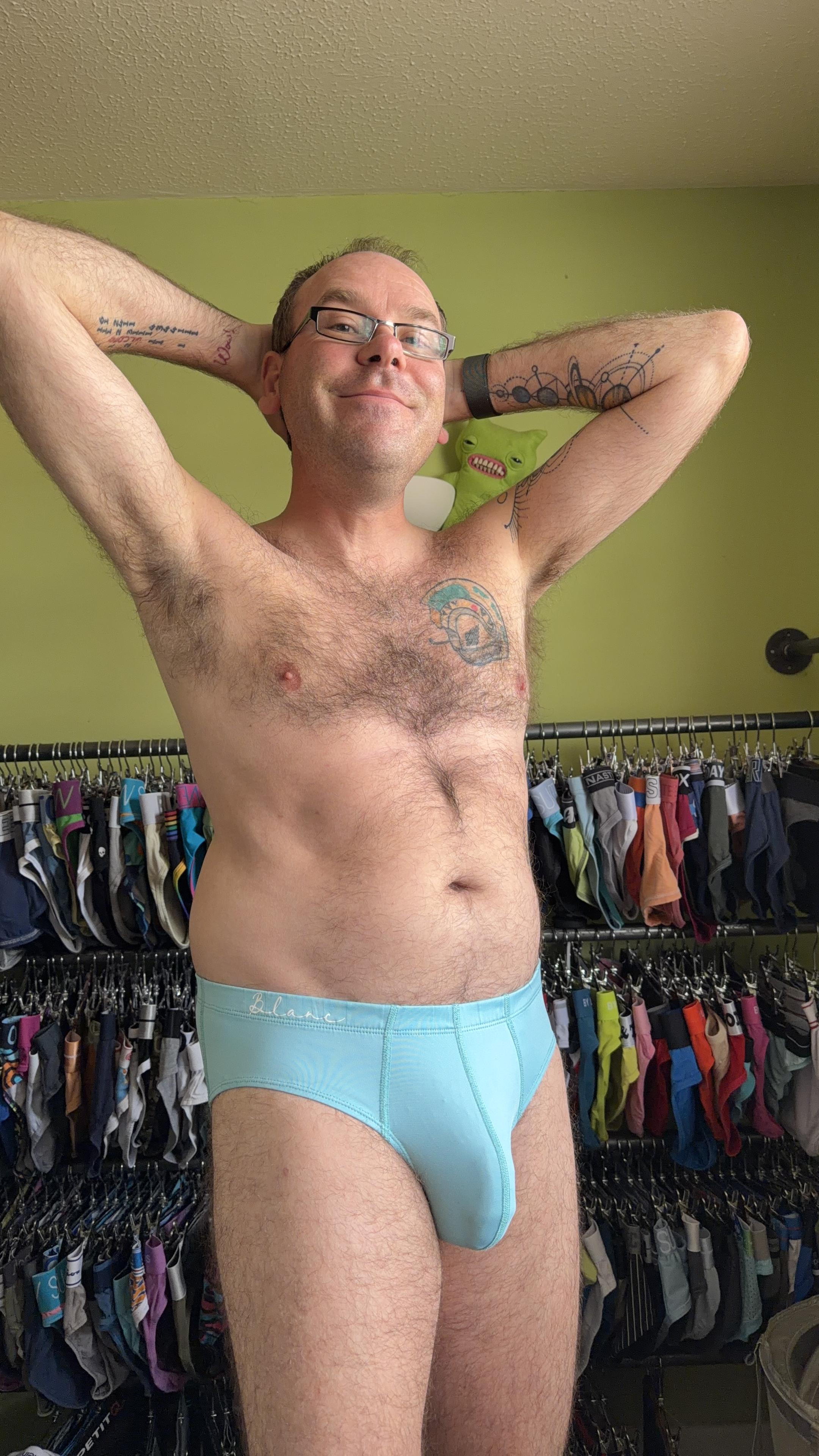 Hairy gay guy wearing cyan blue Blanc briefs