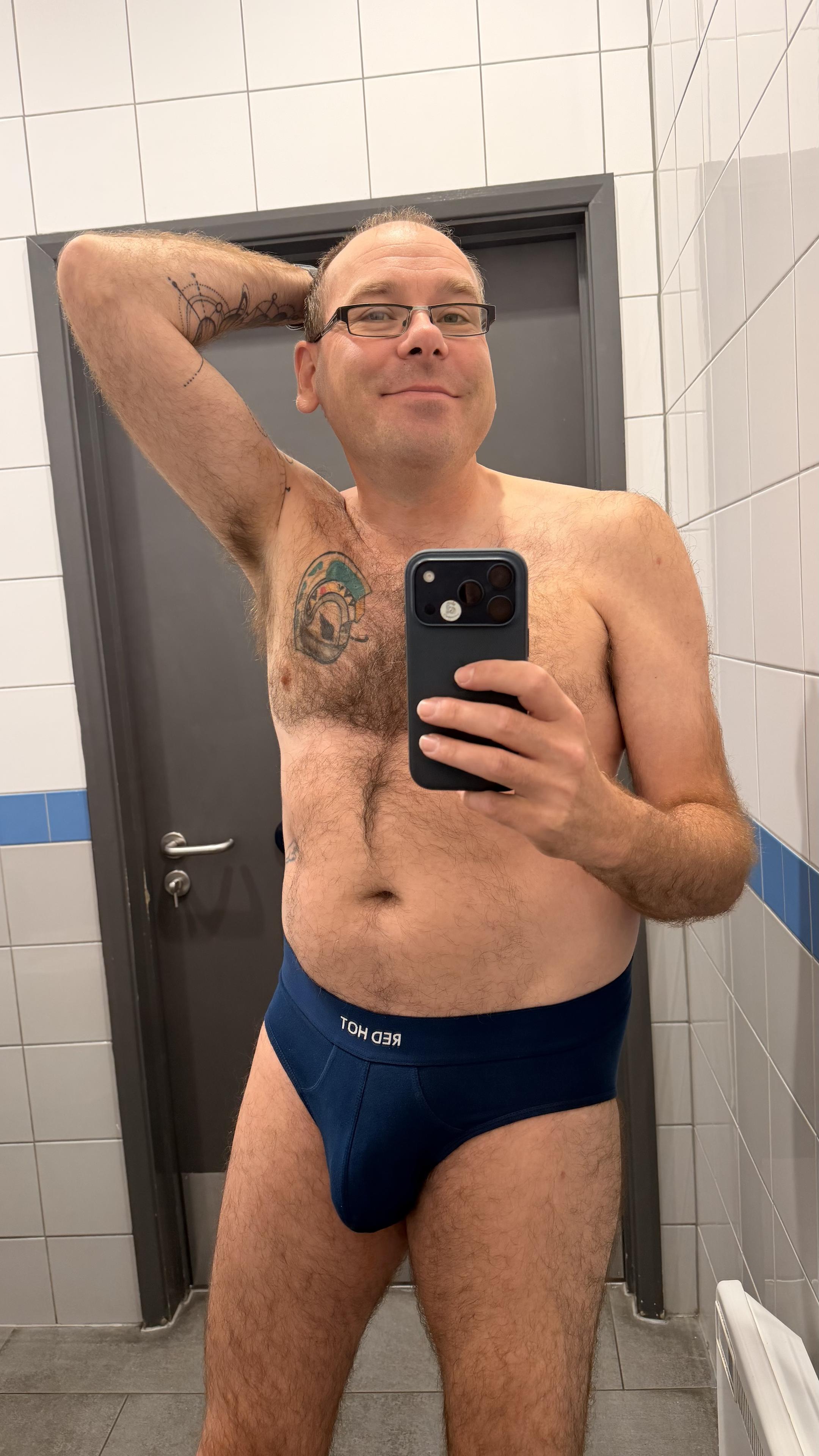 Hairy gay guy wearing dark blue Red Hot briefs