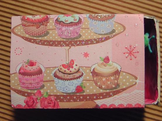 A large matchbox covered in sugar-sweet muffins paper with lots of pink and glitter. This little girl unicorn princess style.