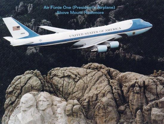 The big plane flies over Mt Rushmore.