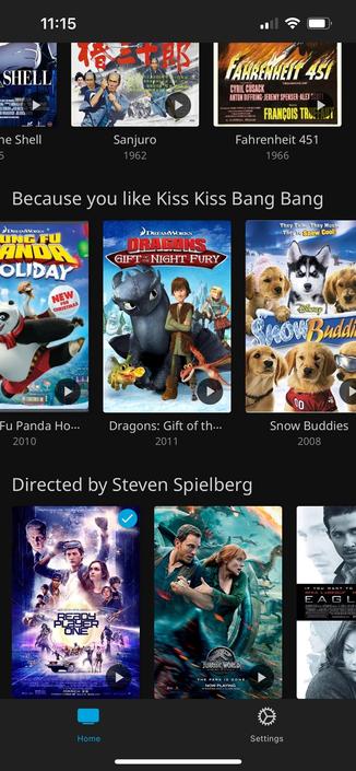 A phone screenshot of Jellyfin on iOS. In the center of the screen is a section labeled “Because you like Kiss Kiss Bang Bang” and the three movies in that section that are visible are King Fu Panda Holiday, Dragons: Gift of the Night Fury, and Snow Buddies.