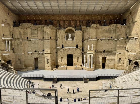 View over seating towards stage; a statue of the emperor occupies a prominent position
