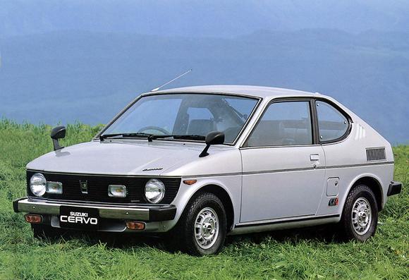 A 1977 Suzuki Cervo in silver, on a grassy field.