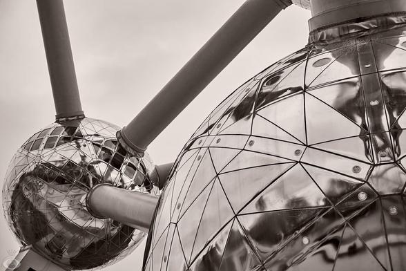 All three images are details of the Atomium: 9 gigantic (18m diameter) Stainless steel clad spheres joined together with steel tubes (which hold the escalators and elevators) shaped together in unit cell that represent an iron crystal, magnified 165 million times.