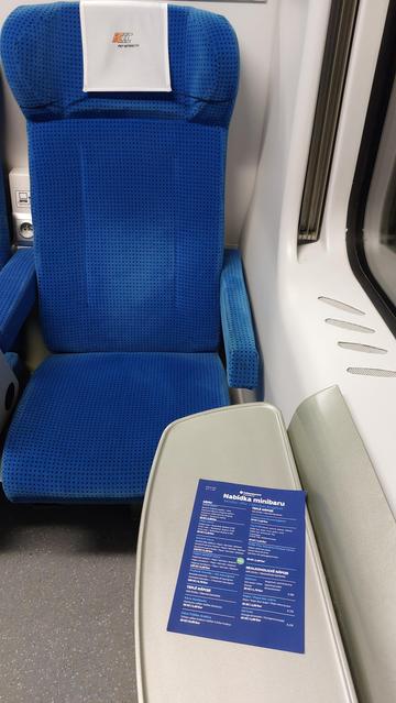 A photo of a seat in a train compartment with minibar menu of ČD (didn't arrive)