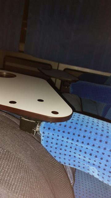 A photo of a handrest and a table with lack of space
