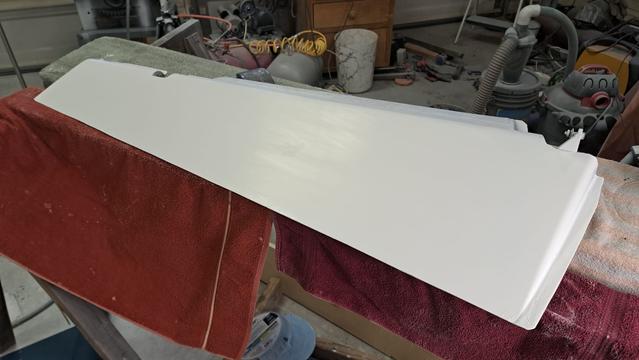 The glider rudder has been wet sanded to 1200 grit. It has a matte finish, but faint hints of specular reflection of the ceiling lights.