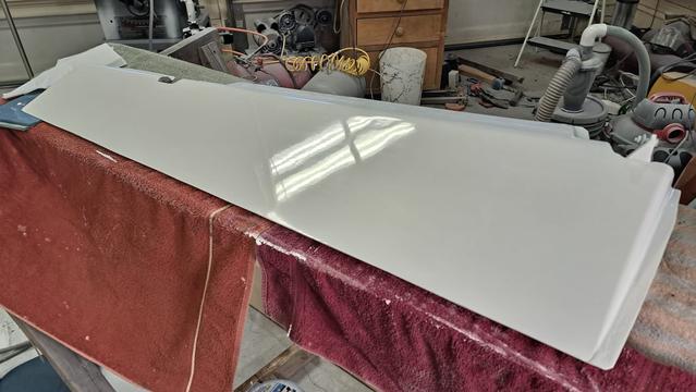 A mirror finish shows the ceiling lights well after coarse polishing.