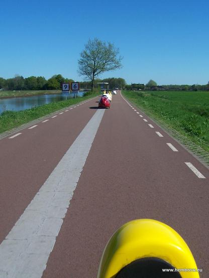 A group of velomobiles going along a fietssnelweg in the Netherlands.