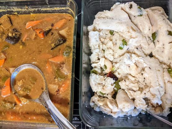 2 rectangular glass bowls - left with brownish liquid - daal and cut vegetables in it, and on right a mass of soft uppuma with pieces of jalapeno and some dried red chillis and cashews too