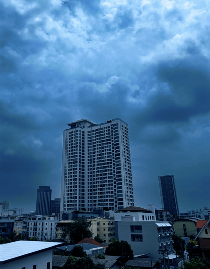 Dark clouds hover over buildings. Heavy down pour expected but usually short. Captured with Google Pixel in Bangkok Thailand