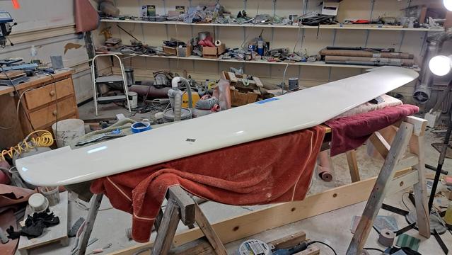Glider horizontal stabilizer on sawhorses. A single edge razor sits on the stabilizer.