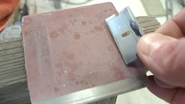 Sanding/sharpening the razor-scraper. This is 400 grit sandpaper.
