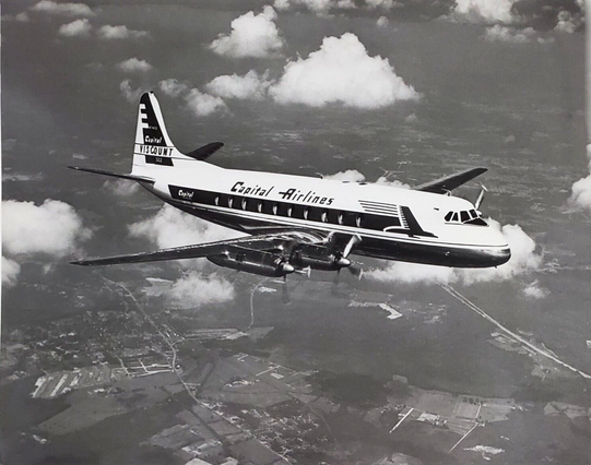Black and white photo of the plane over the American Landscape.
