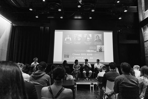 Black and white photo of a stage talk with restaurant owners.