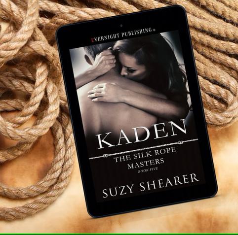 Book cover on an ereader. Cover description: The back of a shirtless man being hugged by a woman with long hair.
Title : Kaden Silk Rope Masters book 5.
The ereader is laying on a messy pile of ropes.