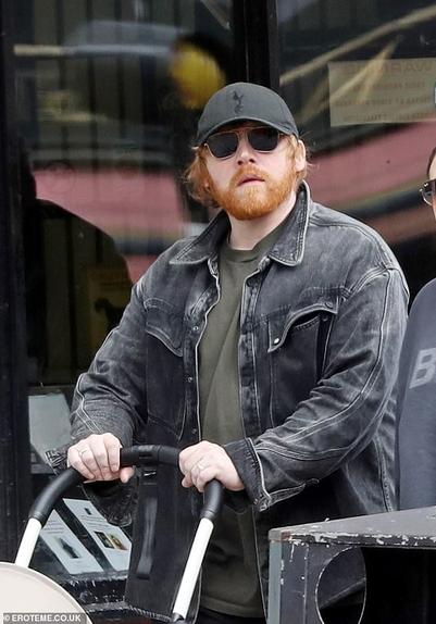 Rupert Grint was every inch the doting dad on Friday as he pushed new baby Goldie in a pram during a low-key stroll in Highgate, North West London