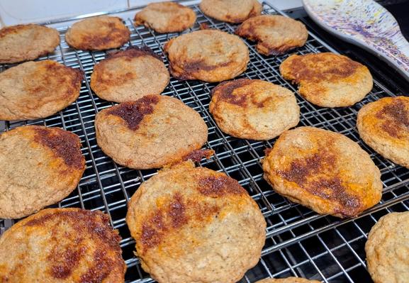 Top/Side-on view of cookies cooking on a wire rack. They are basically a sugar cookie with a red/brown Gochujang (hot Korean bean paste), butter and brown sugar vein/swirl/dollop in contrast to the browned sugar cookie batter.

They are very good but extremely sweet.