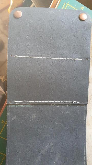 Belt loop finished. Next are the bases for the button fasteners, then glue and stitch the two sides. Hard to see holes for stitching on the black leather!