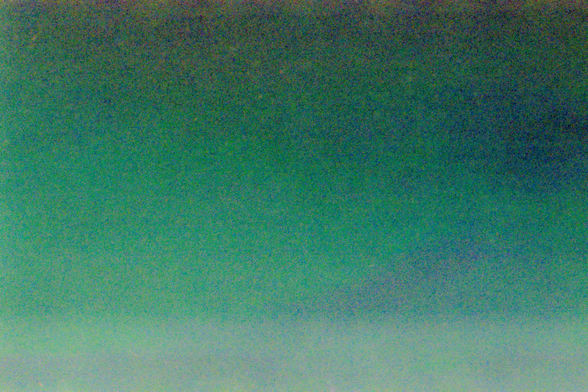 A shifting field of grainy greens and blues with a touch of ruby above and below.