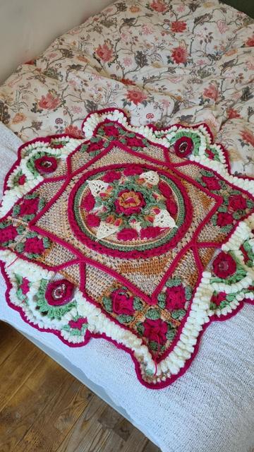 Bright pink, green, beige and white voluminous crochet pattern with flowers and geometrical figures