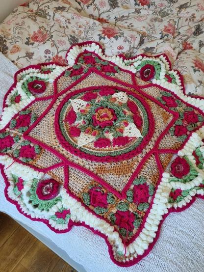 Bright pink, green, beige and white voluminous crochet pattern with flowers and geometrical figures