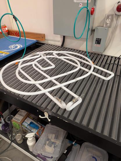 Big 18mm white phosphor tubes sitting on the Urbanglass bombarding table. A "U" sits underneath a "G"