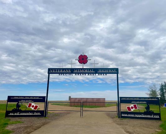 Enterance gate to Veterans Memorial Highway (Hwy36) rest area with a poppy and crosses on top and kneeling soldiers on the sides, english L and french R:
We will remember them/nous nous rappellerons d'eux