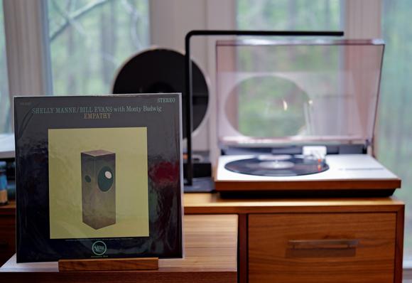 Shelly Manne/Bill Evans - Empathy LP cover.

A rectangular solid on a light green background with a black border. The solid has a few holes.

The black LP plays on a vintage, restored Bang & Olufsen Beogram 4000 linear-tracking turntable to the right.