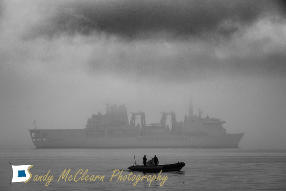 Naval replenishment tanker in thick fog.