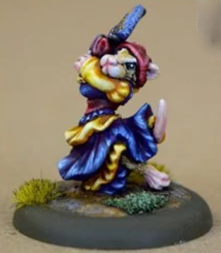 We have an 28mm anthropomorphic mouse. She's wearing a long, flowing yellow and blue dress and her hands are by her face holding some blue fans. She has a red hat on her head and she's dancing.
