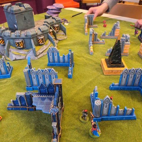 A vibrantly coloured scifi battle field, covered in blue and yellow ruins.