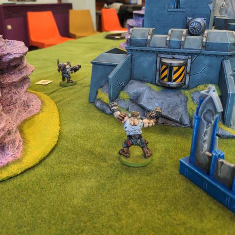 A pair of sneaky model ogryns make there way round a fortified position preparing to rain down heavy gunfire on the enemy.