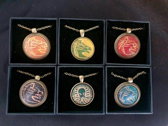 Dragon necklace, brass pendant with a veg tan leather insert and brass chain. Hand-tooled and hand-dyed.