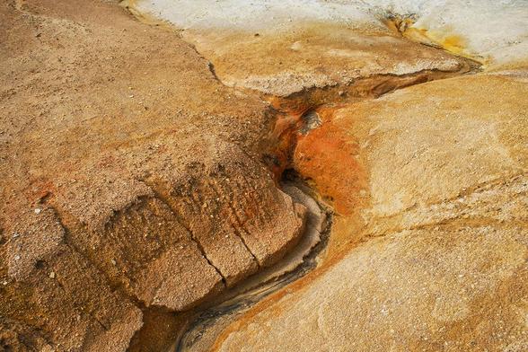 Volcanic landscape with rusty earth and crack in iceland