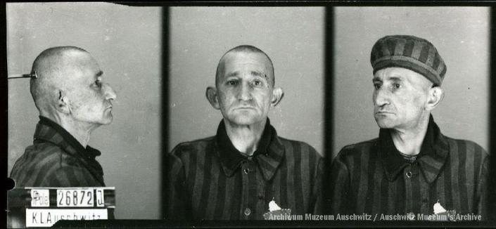 A mugshot registration photograph from Auschwitz. A man with a shaved head wearing a striped uniform photographed in three positions (profile and front with bare head and a photo with a slightly turned head with a hat on). The prisoner number is visible on a marking board on the left.