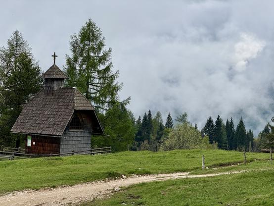 Wooden chapel surrounded by pasture