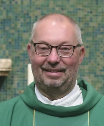 Father Darren Reid smiling