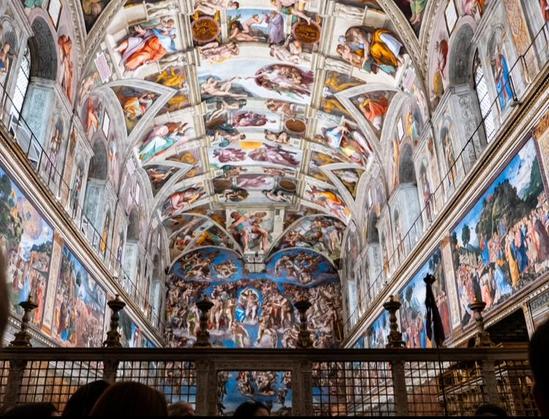 Inside the Sistine Chapel, from behind looking towards the altar where Michelangelo's The Last Judgement can be seen.
Michelangelo’s frescos can be seen including the ceiling paintings which The Creation.of Adam, is seen at the top of photo.
Located at Vatican City, Rome, Italy.