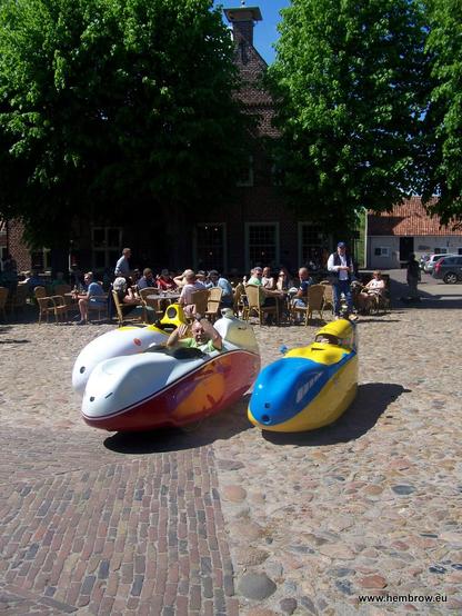 Three velomobiles parked in the centre of Bourtange. It's a real tourist trap inside this fortress town. Lots of people occupying the cafe seats and eating giant piles of food because they've expended so much energy driving there and back. It took ages before we could sit and drink coffee.