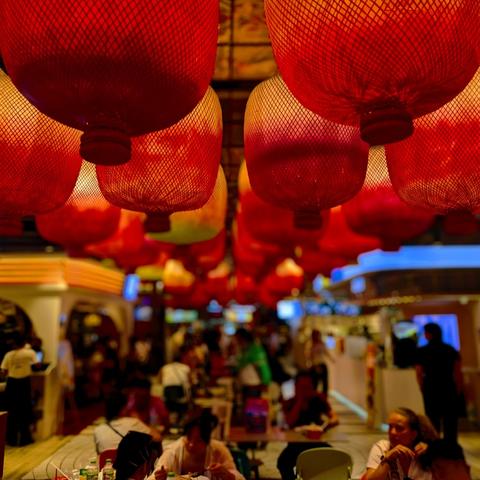 Red lamtern hanging from above dining area. Captured with Google Pixel in Bangkok Thailand