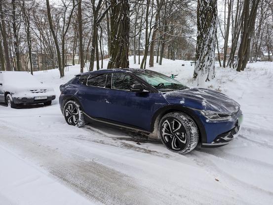 Blue Kia EV6 in snow, somewhere in the Northern Europe.
