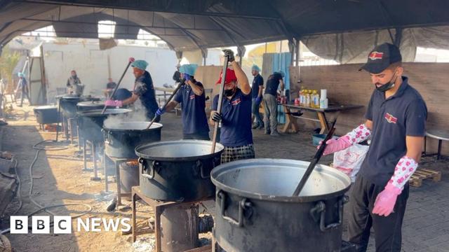 Cooks stir pots of rice and lentils at a community food kitchen run by the US-based humanitarian organisation Anera in Khan Younis, southern Gaza