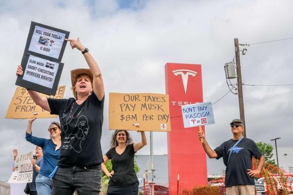 Protesters demonstrate against Tesla CEO Elon Musk’s "Department of Government Efficiency" (DOGE) initiatives during a nationwide “Tesla Takedown” rally at a dealership on March 29, 2025, in Austin, Texas.