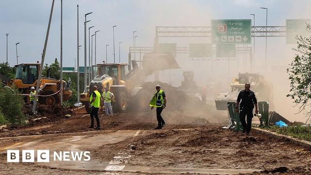 Israeli emergency services clear a road outside Israel's Ben Gurion airport.