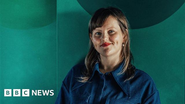 Sabine Zetteler in a blue shirt against a green background