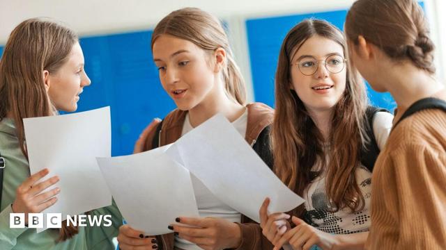 Four female students opening their exam results at school. They are wearing casual clothes, smiling, and holding up paper results